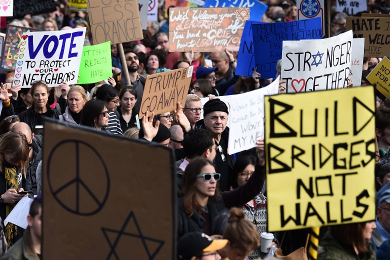 People protest the arrival of President Donald Trump as he visits the Tree of Life Congregation on Oct. 30 in Pittsburgh.